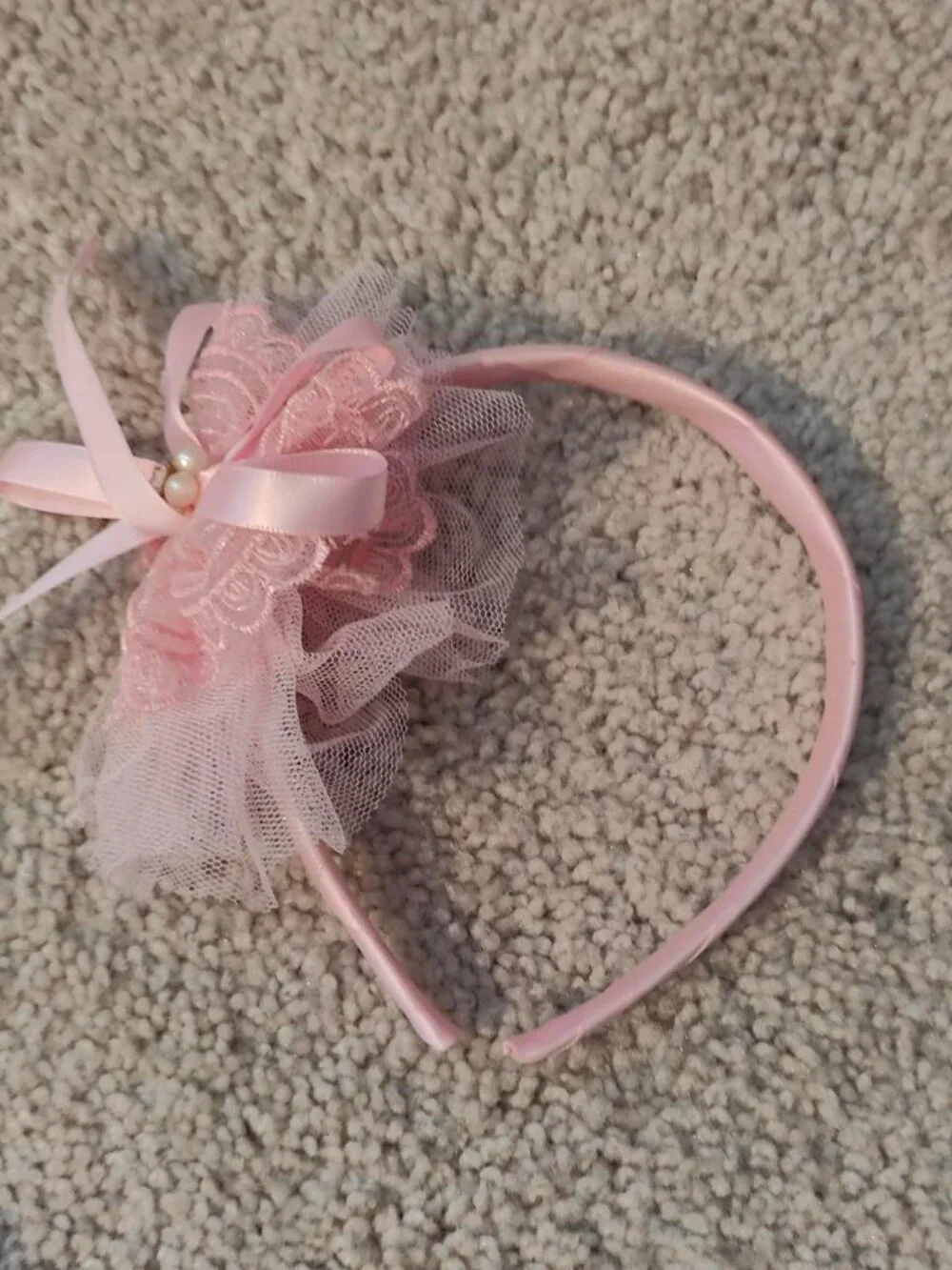 Pink lace headband with bow and pearl detail